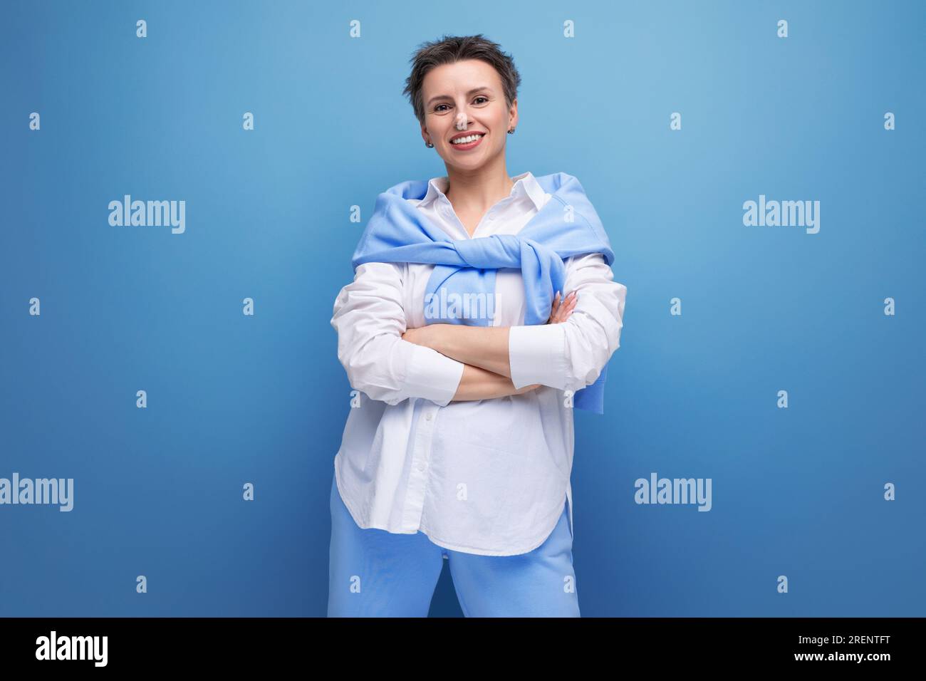cheerful bright cheerful young dark-haired woman with a short haircut in a white shirt Stock Photo