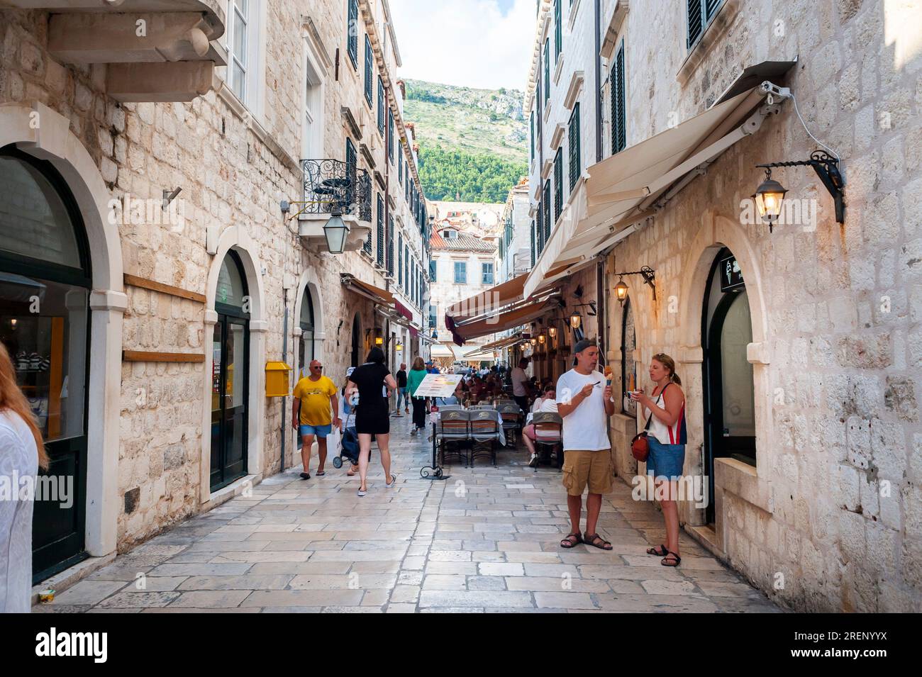 Dubrovnik, Croatia, Medium Crowd People, Tourists Walking, Visiting CIty Historic Neighborhood, Alleyways, Stradun Stock Photo