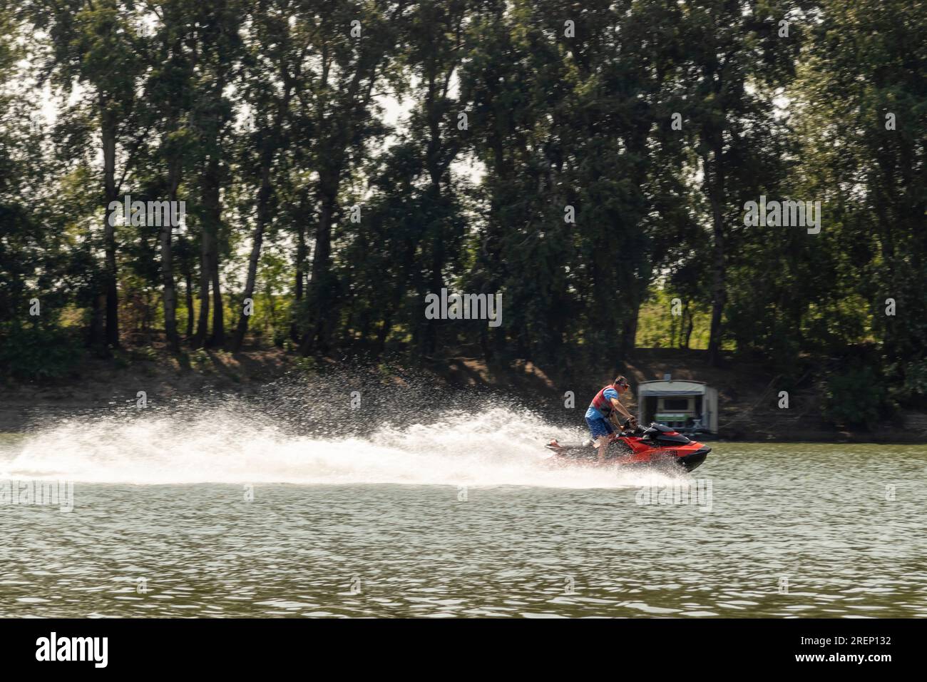 Man riding water scooter on river Stock Photo - Alamy