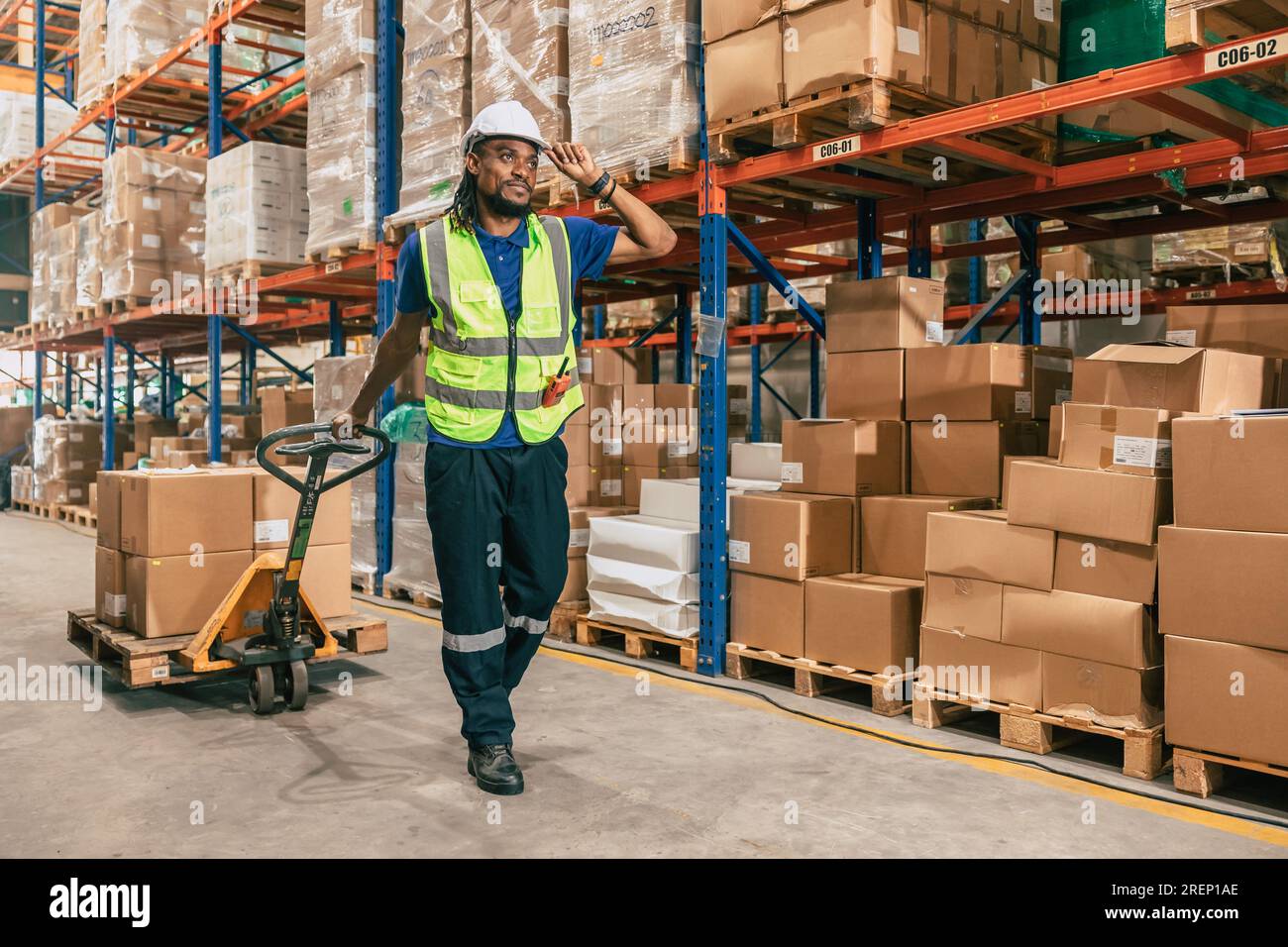 warehouse worker using parcel pallet in cargo shipping logistics ship supply management employee workplace concept Stock Photo