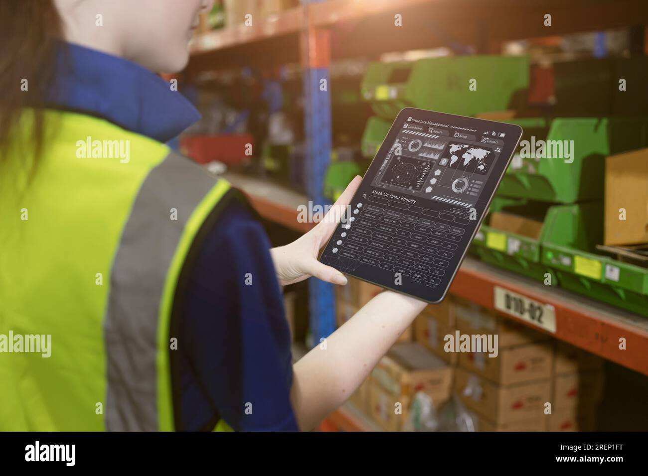 inventory manager worker using warehouse management system on tablet computer for tack checking products lots storage location Stock Photo