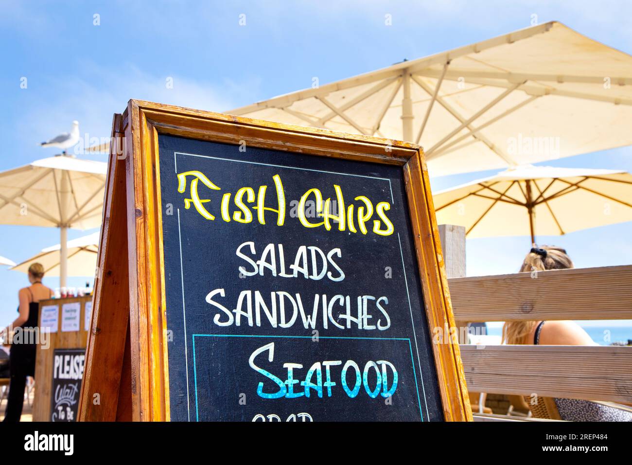 Restaurant sign for fish and chips and seafood along the seaside promenade in Brighton, England Stock Photo