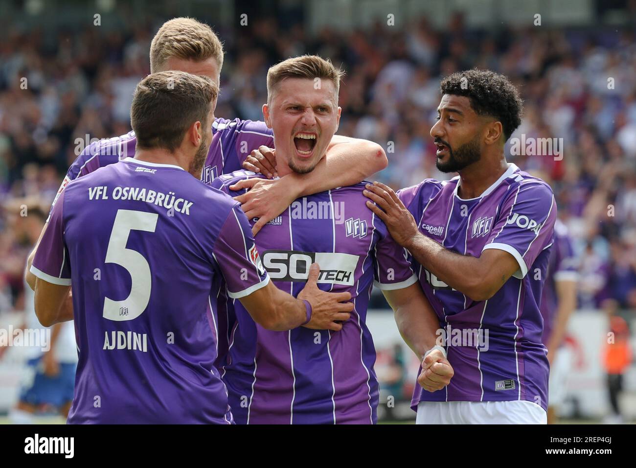 29 July 2023, Lower Saxony, Osnabrück: Soccer: 2nd Bundesliga, VfL Osnabrück - Karlsruher SC, Matchday 1 at Stadion an der Bremer Brücke. Osnabrück's goal scorer Erik Engelhardt (2nd from right) celebrates his goal to make it 1:1 with Bashkim Ajdini (l-r), Lukas Kunze and Noel Niemann. Photo: Friso Gentsch/dpa - IMPORTANT NOTE: In accordance with the requirements of the DFL Deutsche Fußball Liga and the DFB Deutscher Fußball-Bund, it is prohibited to use or have used photographs taken in the stadium and/or of the match in the form of sequence pictures and/or video-like photo series. Stock Photo