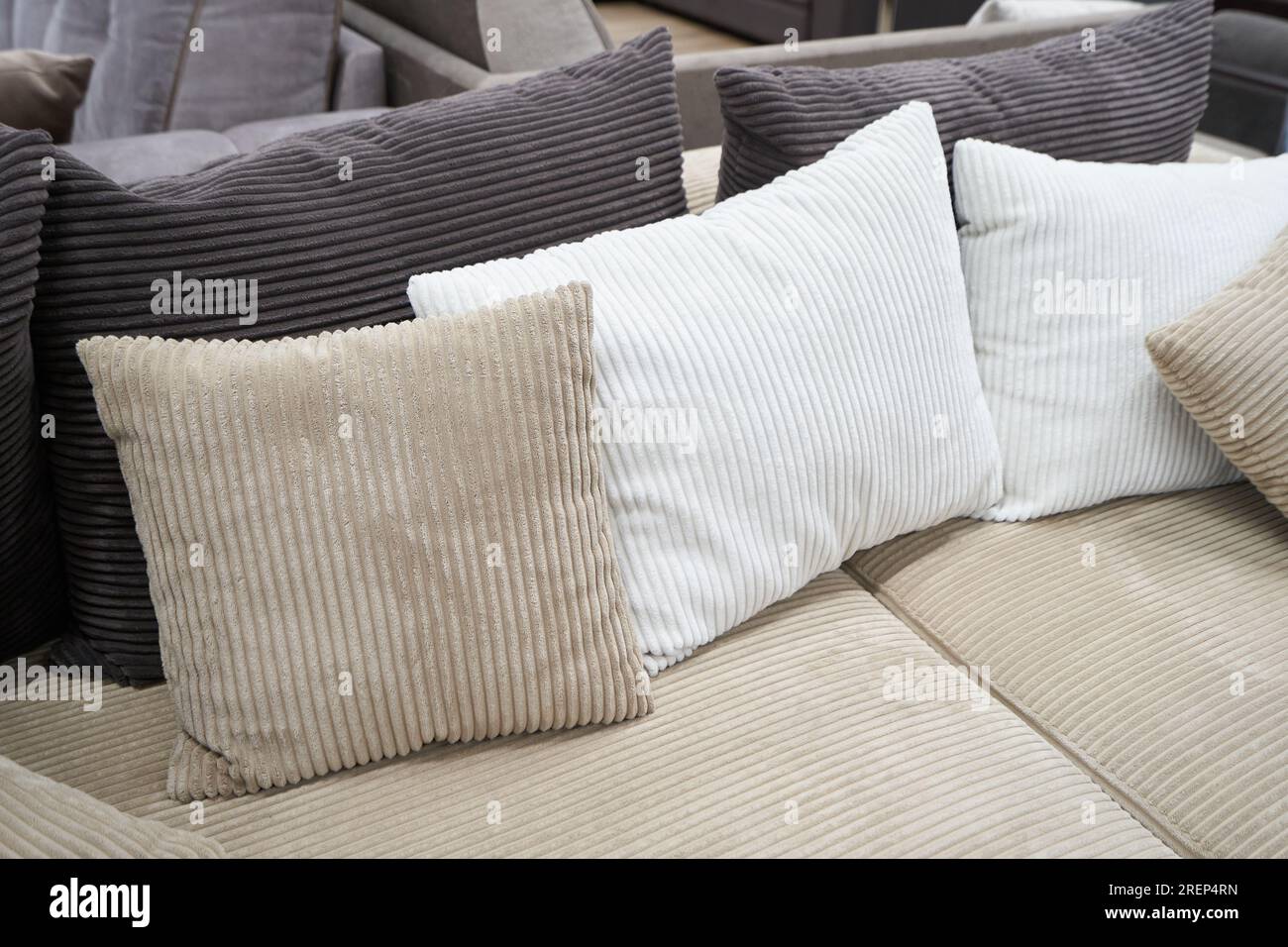 Soft pillows and a sofa made of corduroy fabric Stock Photo