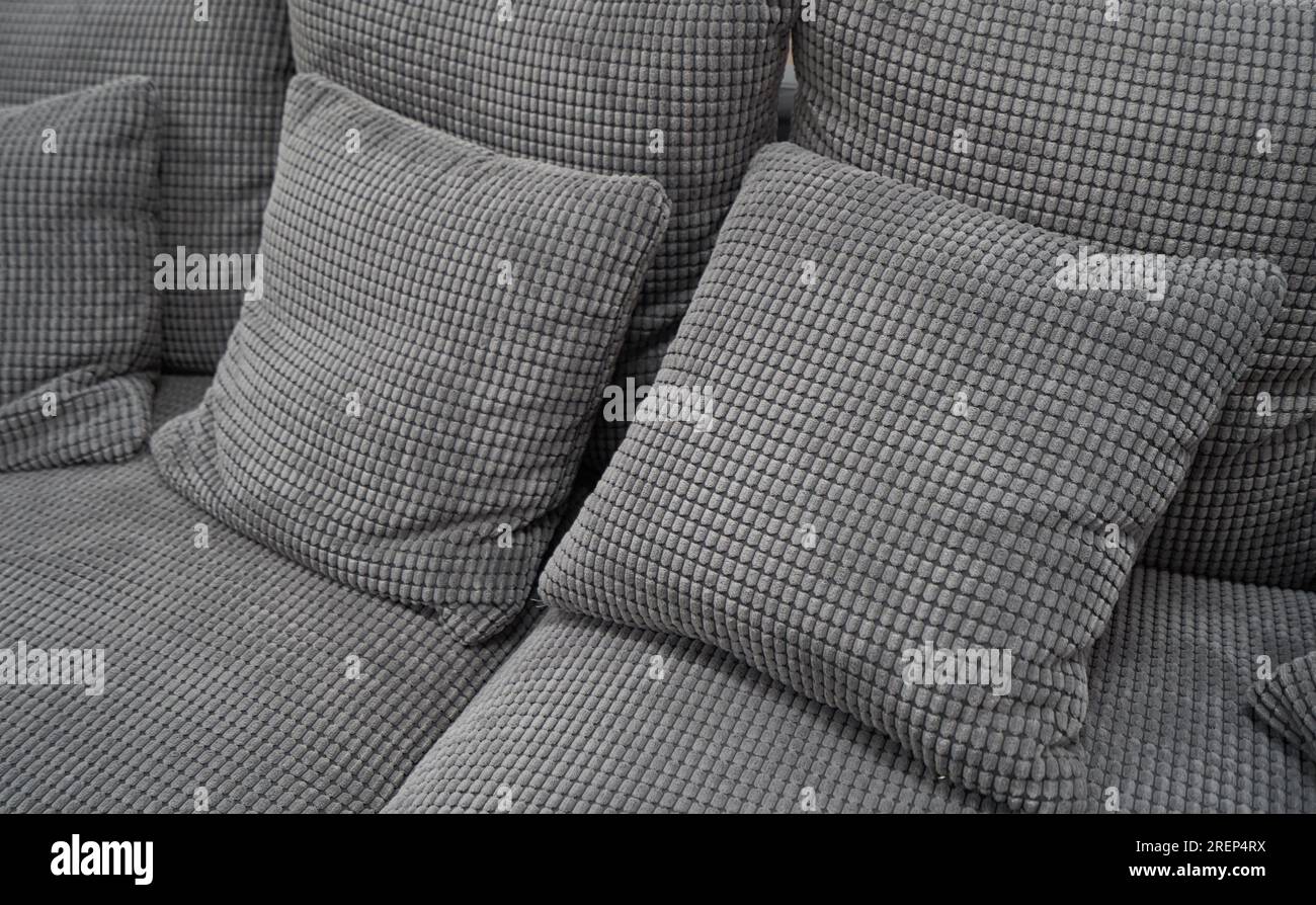 Soft pillows and a sofa made of corduroy fabric Stock Photo