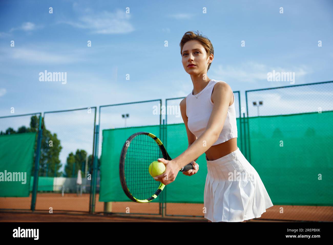 Focused pretty female tennis player preparing to hot ball Stock Photo -  Alamy