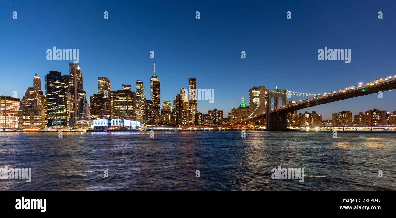 New York City's Brooklyn Bridge and Manhattan skyline illuminated at ...