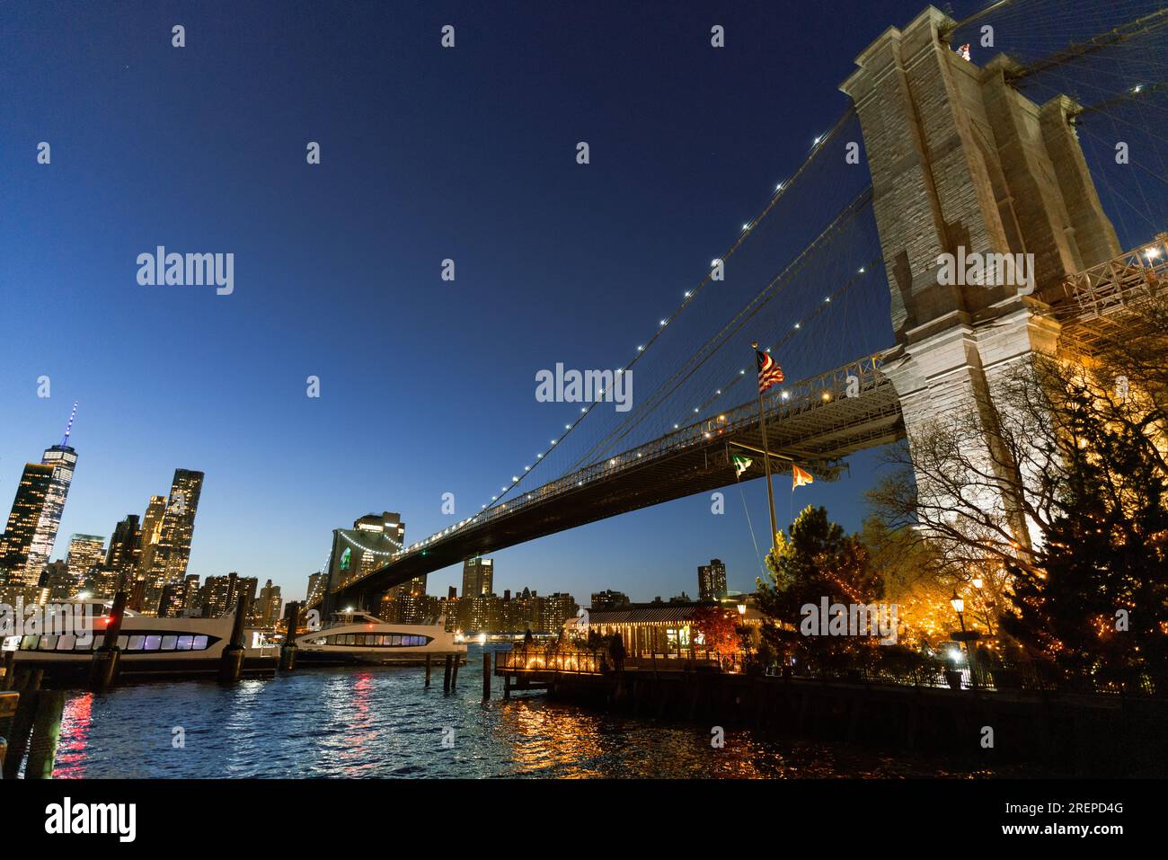 New York City's Brooklyn Bridge and Manhattan skyline illuminated at ...