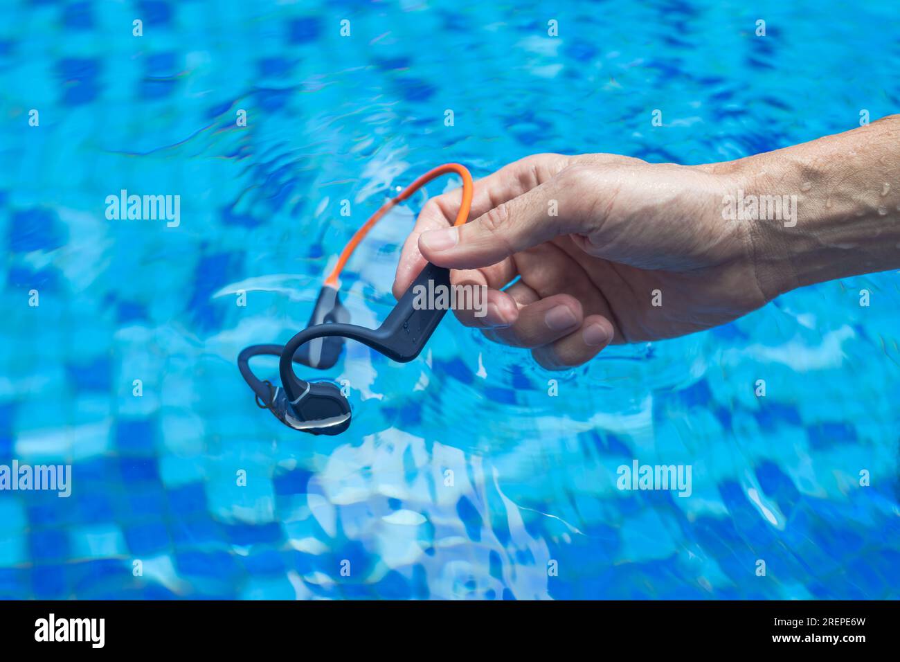 Waterproof audio device submerged in water. Headphones with bone