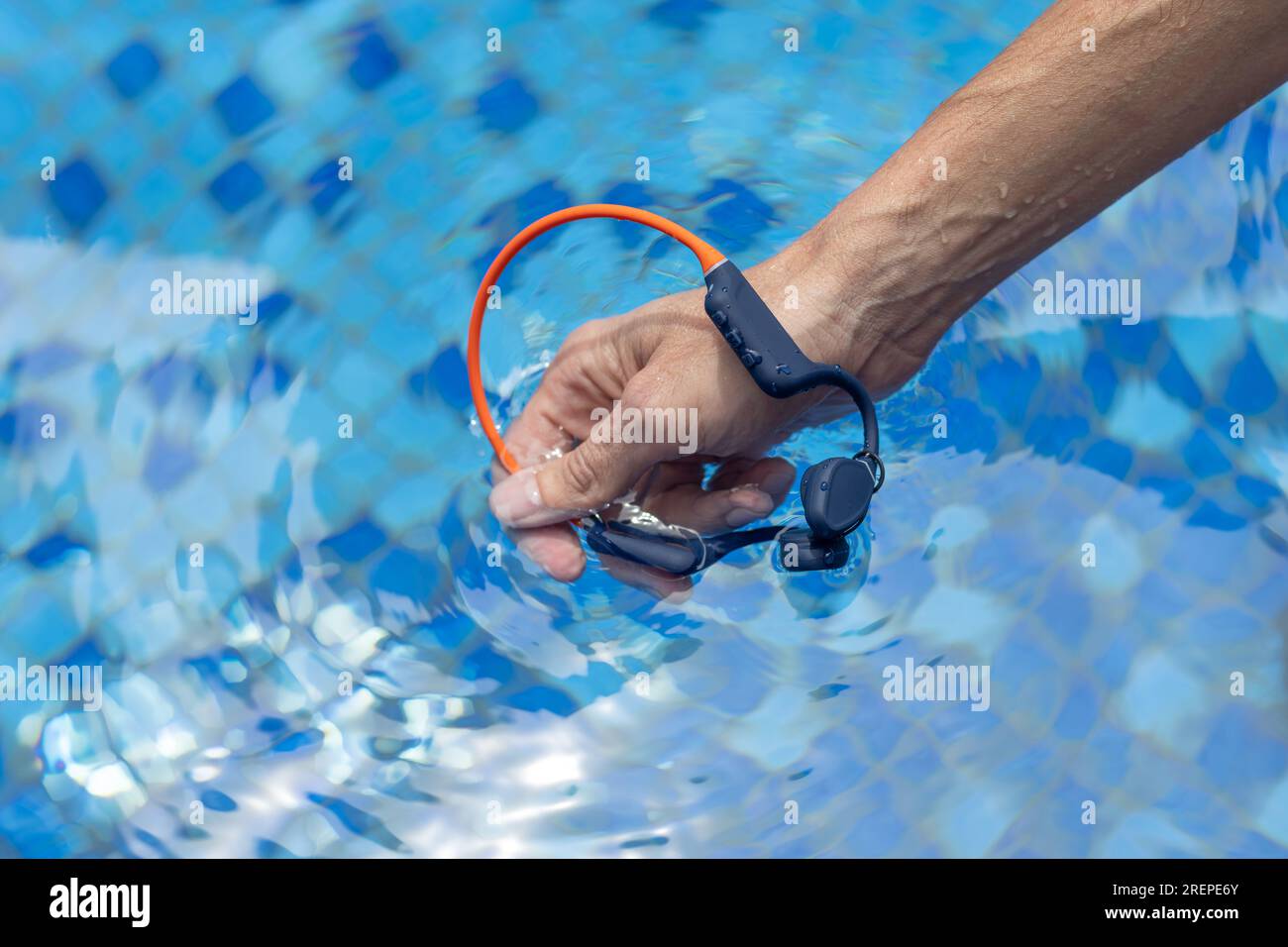 Waterproof audio device submerged in water. Headphones with bone