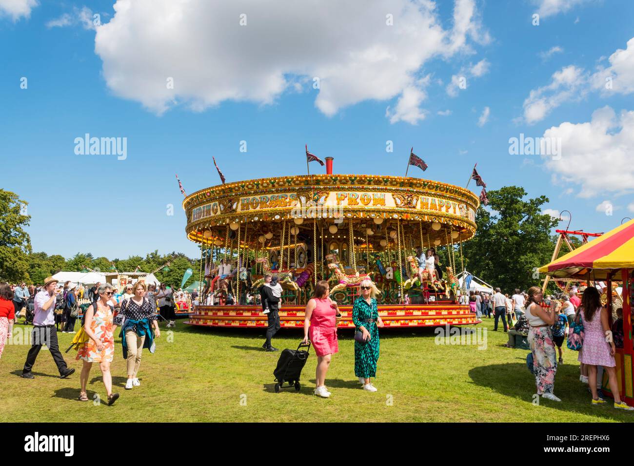 Galloping horses roundabout at Sandringham Flower Show. Stock Photo