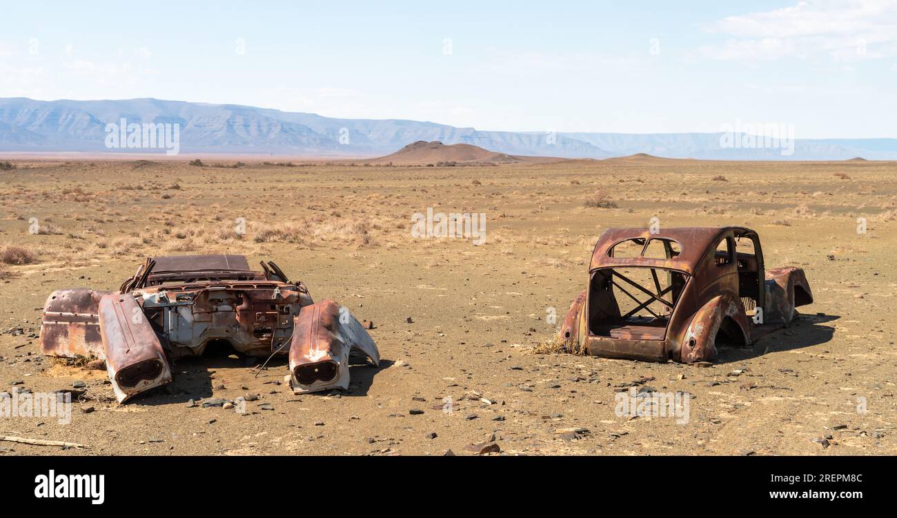 Two wrecks of rusted cars in the desert Stock Photo