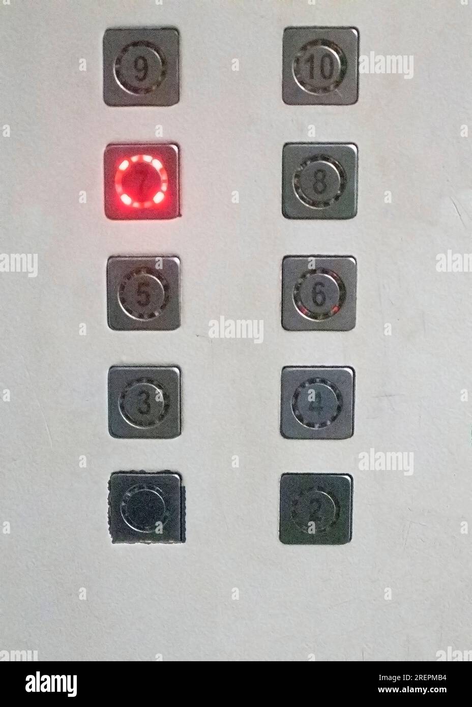 Elevator buttons panel with a seventh floor glowing button Stock Photo