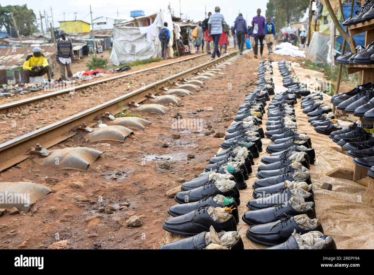 KENYA, Nairobi, Kibera slum, small scale business, shoe sale at railway