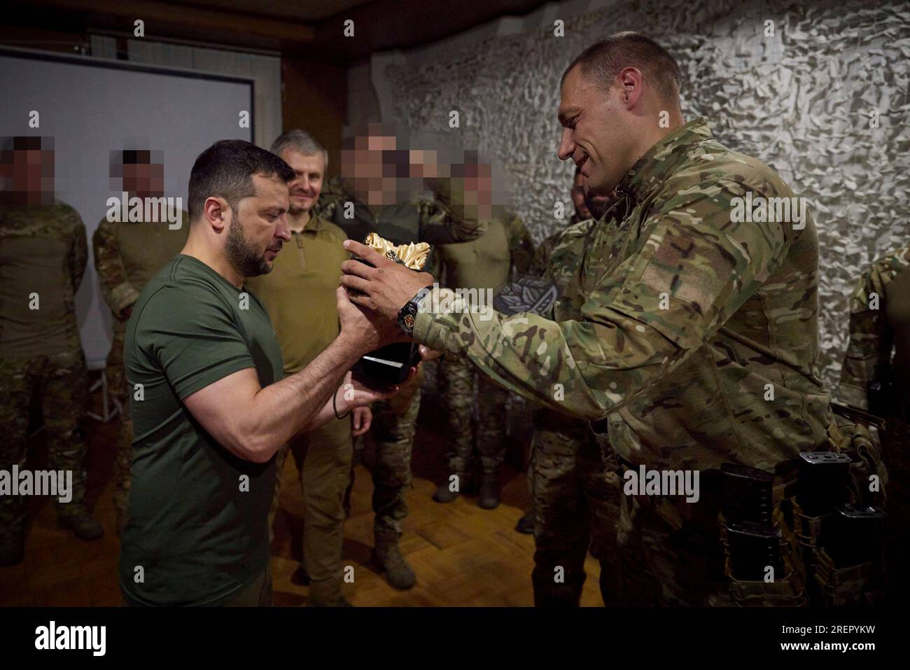 Donetsk, Ukraine. 29th July, 2023. Ukrainian President Volodymyr Zelenskyy, left, is presented a statue of the Silver Wolf by Special Operations Forces, Brigadier General Viktor Khorenko, right, during a visit to frontline positions in the Donetsk region, July 29, 2023 in Donetsk Oblast, Ukraine. Zelenskyy visited SOF commandos to mark Special Operations Forces Day and stopped at a petrol station along the way to greet supporters. Credit: Pool Photo/Ukrainian Presidential Press Office/Alamy Live News Stock Photo