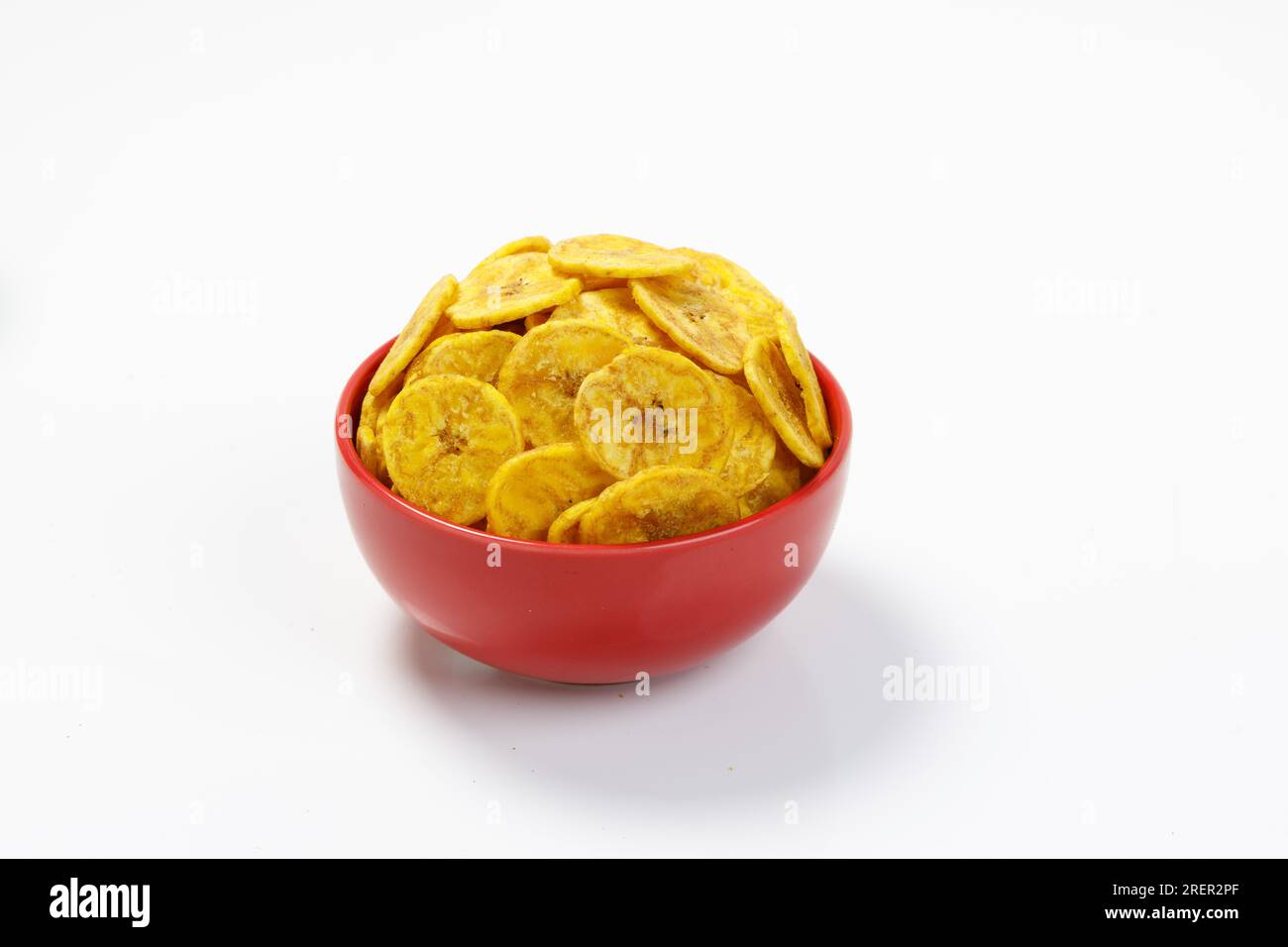 Kerala chips or Banana chips, cult snack item of Kerala, arranged in red bowl,Isolated image with white background Stock Photo