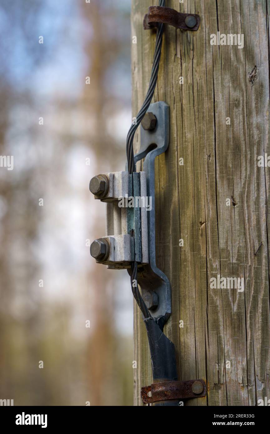 Wire connector for ground wire on a wooden electric pole outdoors