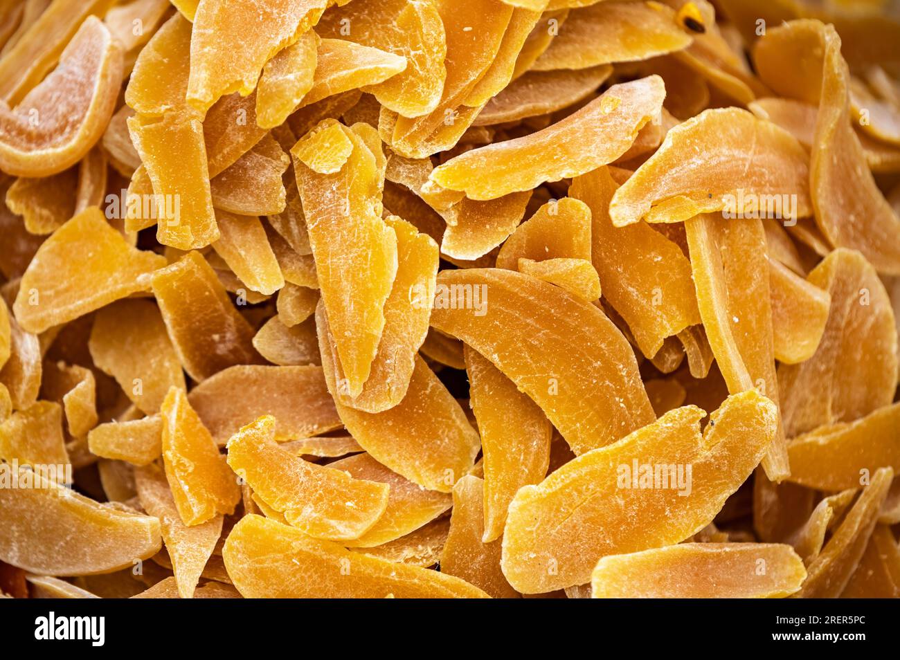 Dried mango slices as background. Candied fruits, mango pieces