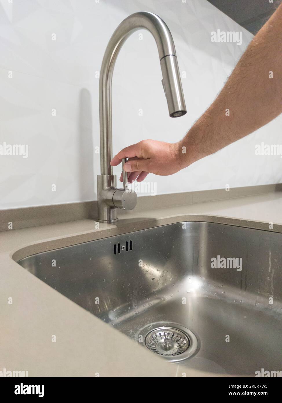 Male hand closing the kitchen sink tap. Selective focus Stock Photo Alamy