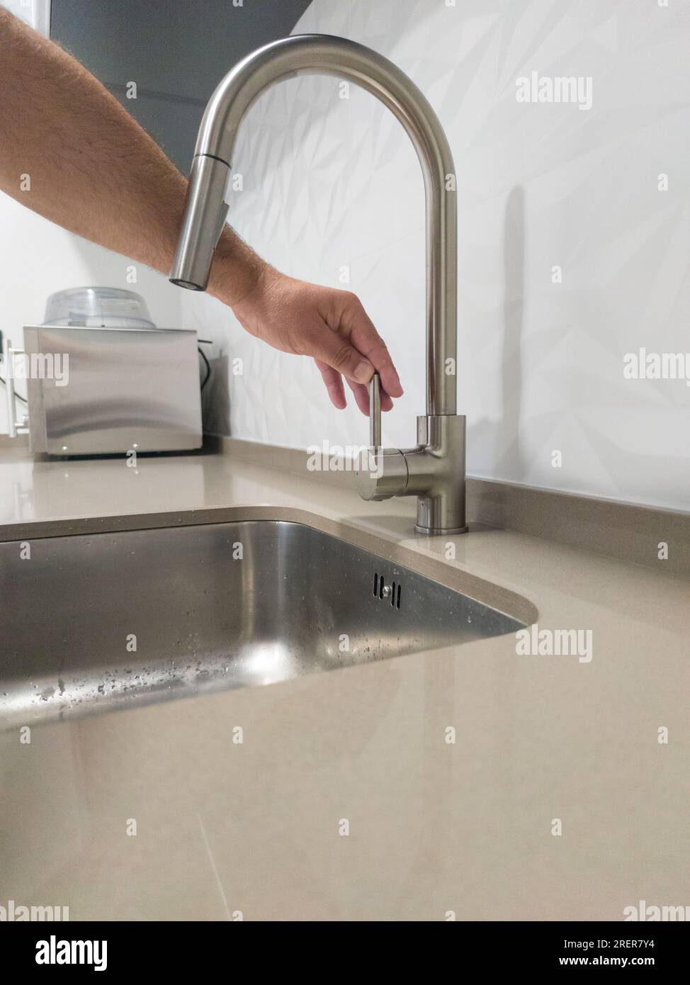 Male hand closing the kitchen sink tap. Selective focus Stock Photo Alamy