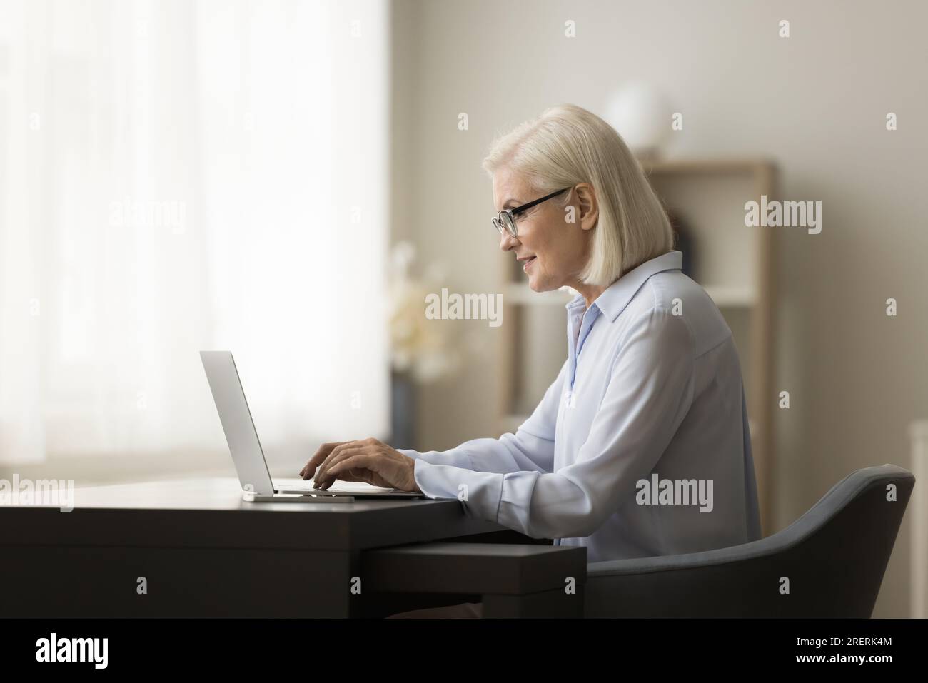 Positive busy senior business woman working from home Stock Photo