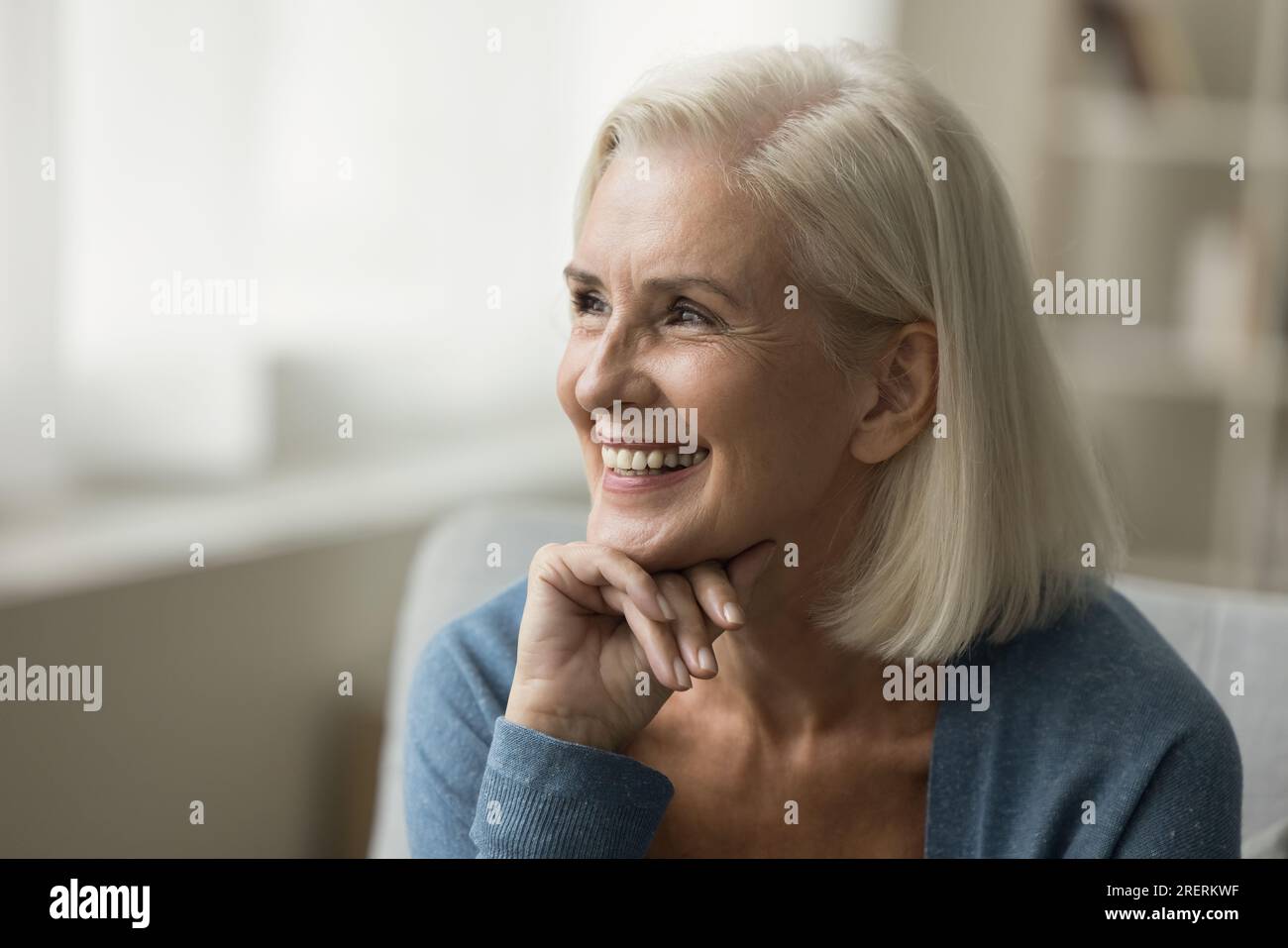 Senior woman sitting on sofa hi-res stock photography and images - Alamy