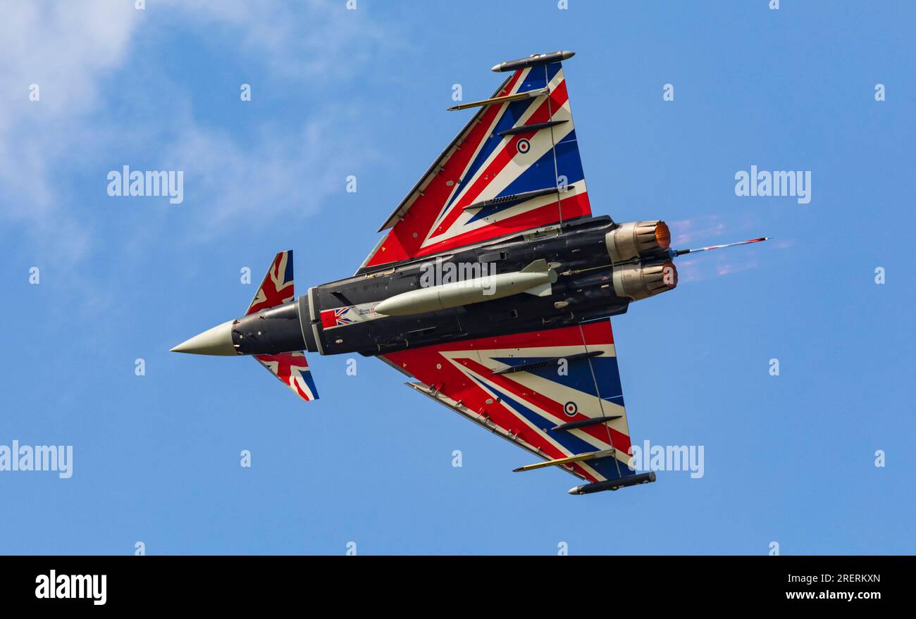 Old Buckenham Aerodrome, Norfolk, UK. 29th Jul 2023. An RAF Eurofighter Typhoon FGR.4 piloted by Flight Lieutenant Matt Brighty from 29 Squadron based at RAF Coningsby in Lincolnshire puts on a dazzling display with his Union Jack emblazoned aircraft at the Old Buckenham Airshow. Credit: Stuart Robertson/Alamy Live News. Stock Photo