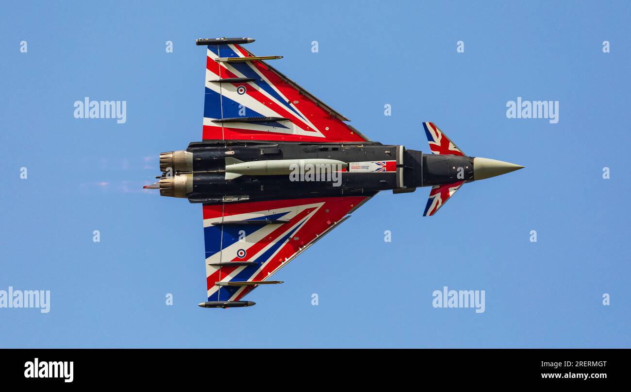 Old Buckenham Aerodrome, Norfolk, UK. 29th Jul 2023. An RAF Eurofighter Typhoon FGR.4 piloted by Flight Lieutenant Matt Brighty from 29 Squadron based at RAF Coningsby in Lincolnshire puts on a dazzling display with his Union Jack emblazoned aircraft at the Old Buckenham Airshow. Credit: Stuart Robertson/Alamy Live News. Stock Photo