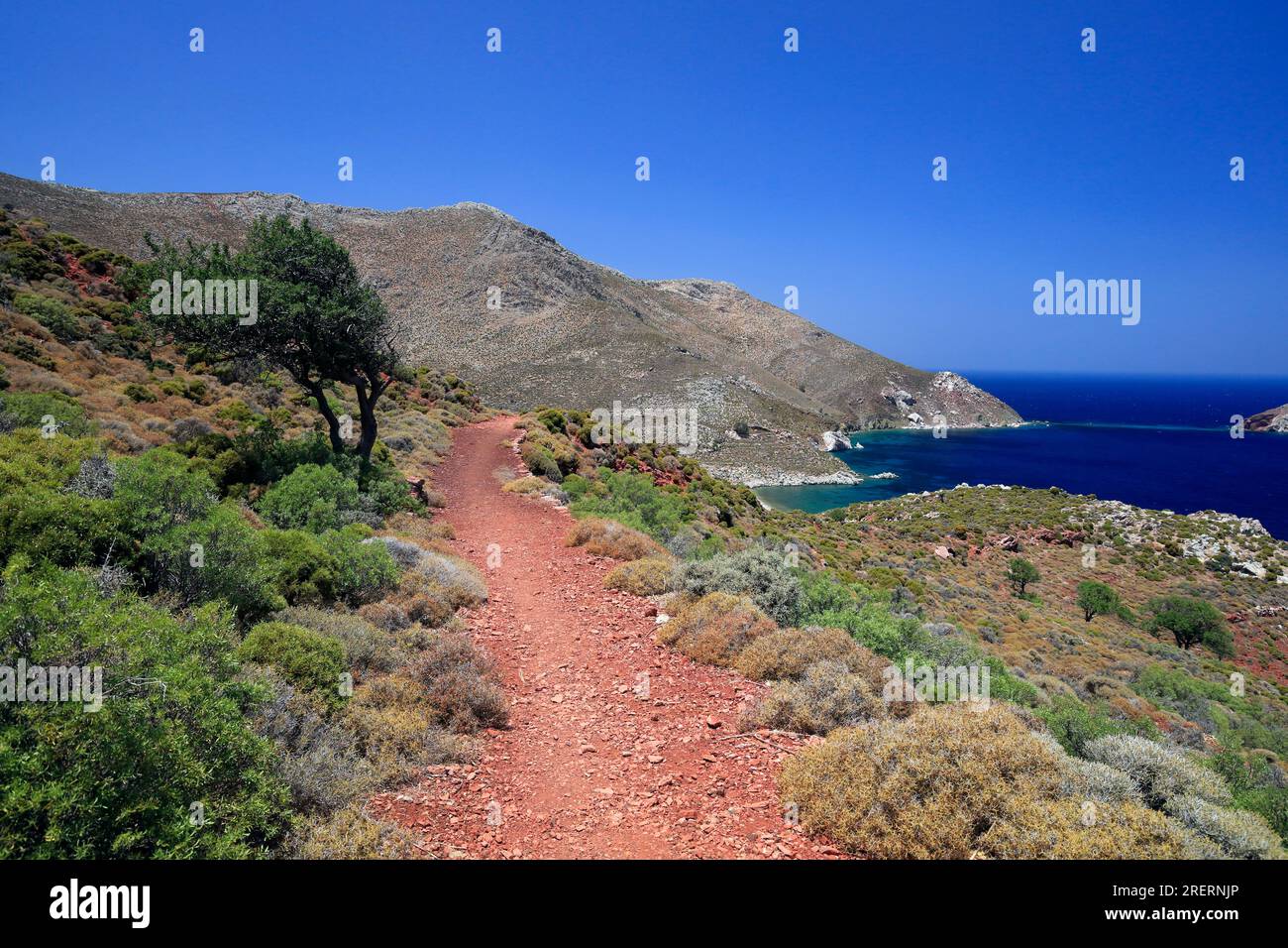 Views on the red soil path from Livadia to Lethra beach along the rocky mountain path, Tilos island, Dodecanese island group. Greece, July 2023. cym Stock Photo