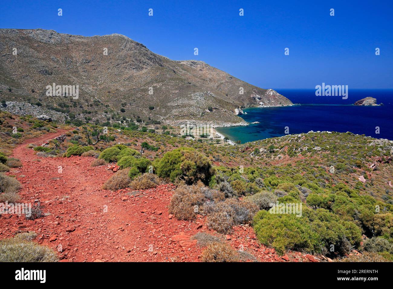 Views on the red soil path from Livadia to Lethra beach along the rocky mountain path, Tilos island, Dodecanese island group. Greece, July 2023. cym Stock Photo