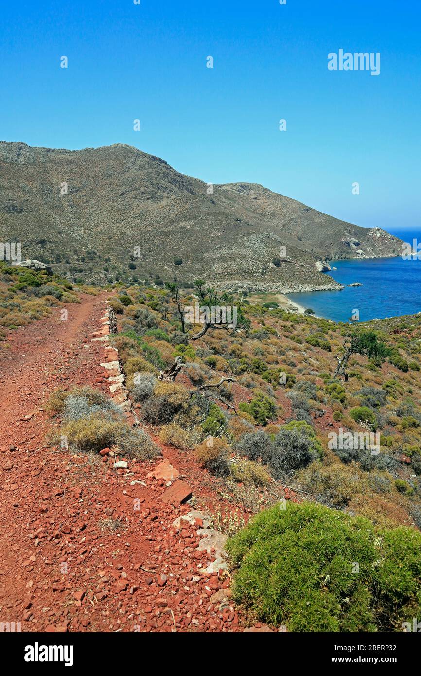 Views on the red soil path from Livadia to Lethra beach along the rocky mountain path, Tilos island, Dodecanese island group. Greece, July 2023. cym Stock Photo