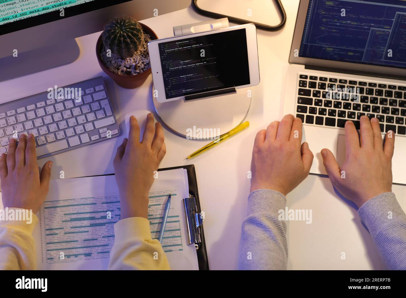 Programmers working in office at night, top view Stock Photo
