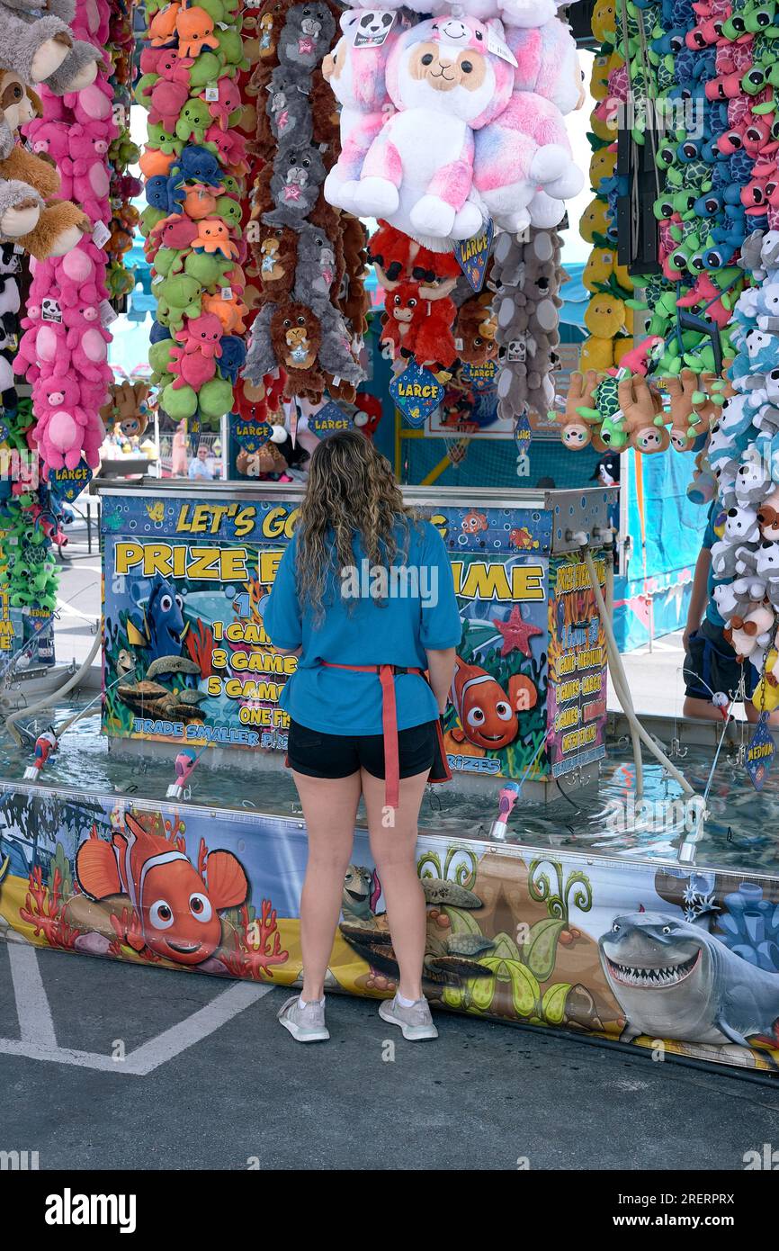 A carnival worker maintains a midway amusement at the 2023 Delaware