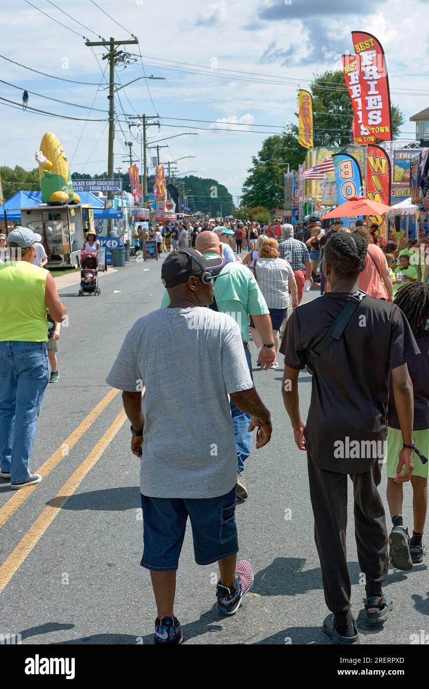 Pedestrians stroll the midway at the 2023 Delaware State Fair, Harrington, Delaware USA. Stock Photo