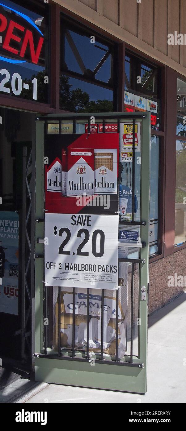 a smoke shop entrance door with Marlboro cigarettes sign in California Stock Photo