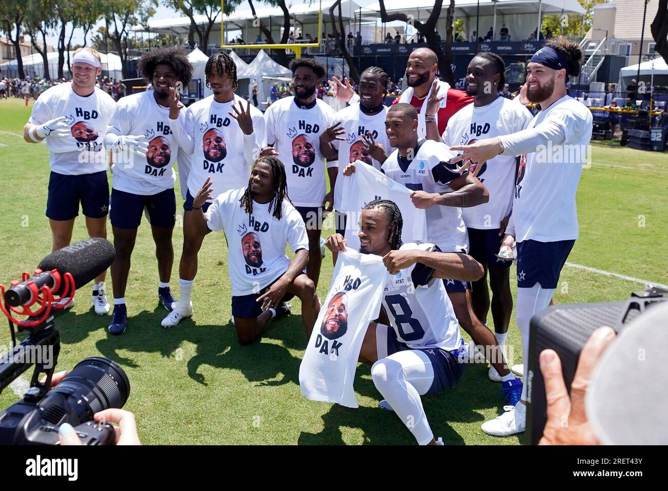 Teammates pose with Dallas Cowboys quarterback Dak Prescott, in