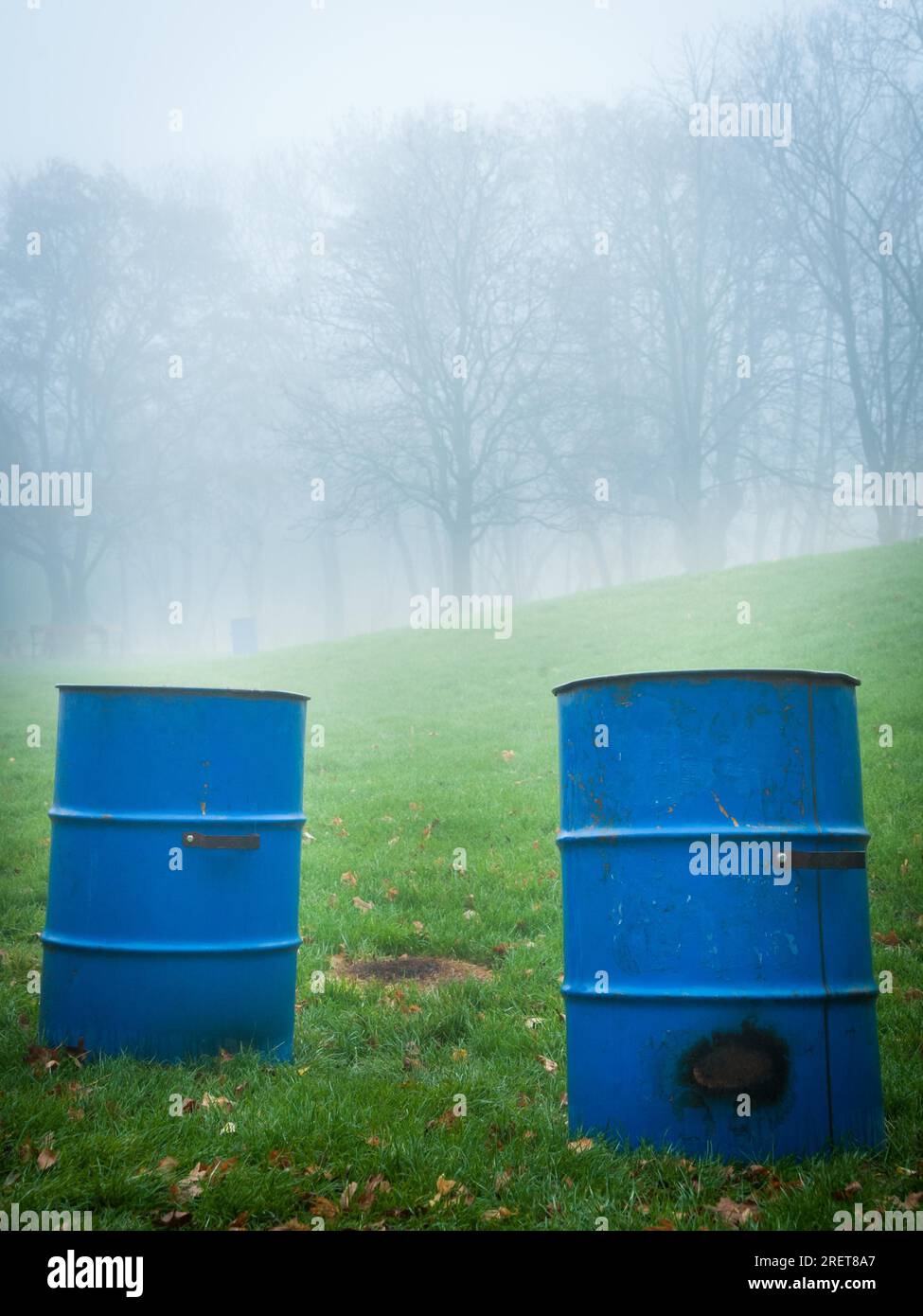 Blue trash bins in a foggy park Stock Photo Alamy