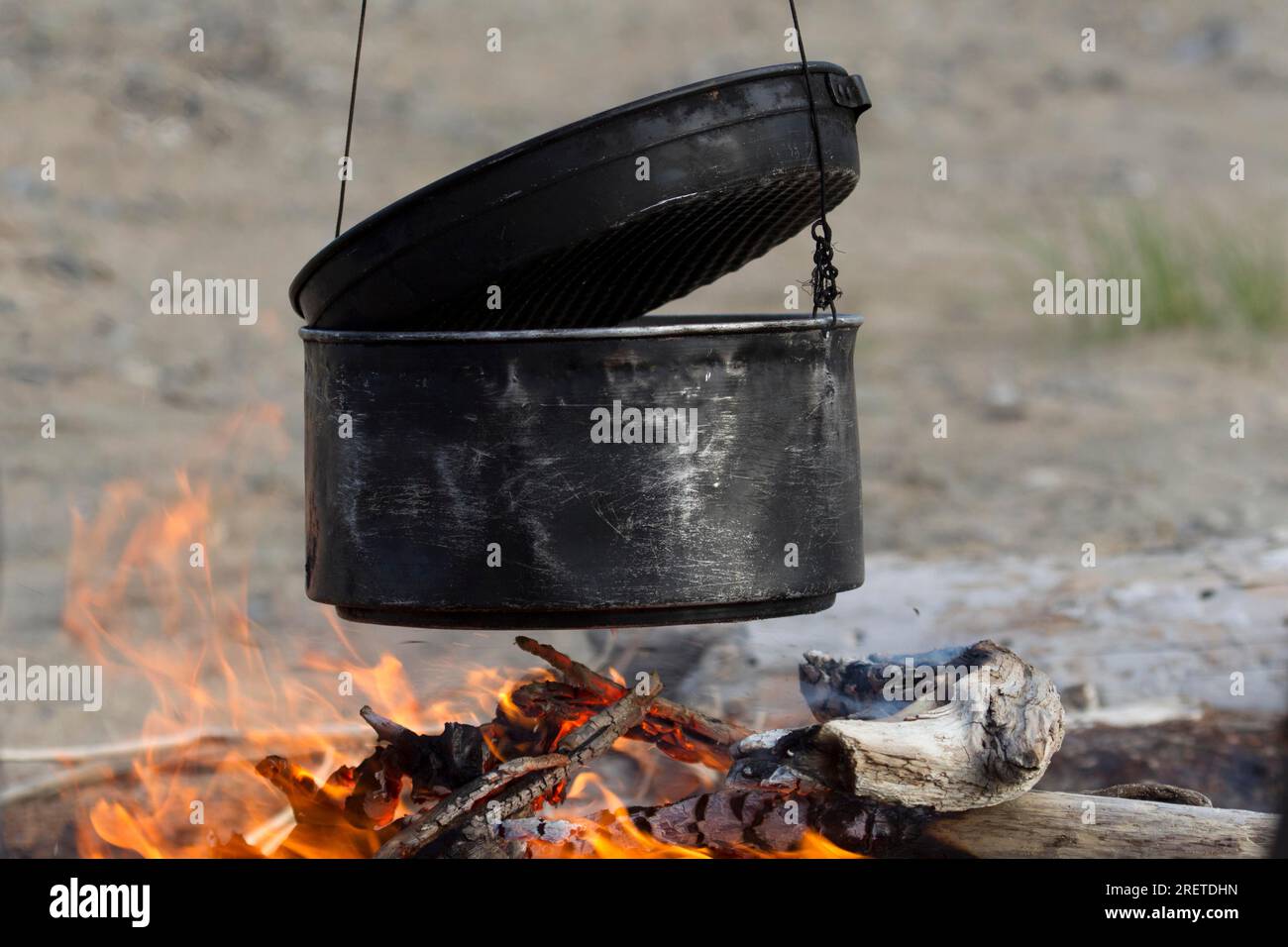 Cooking pot over the campfire Stock Photo