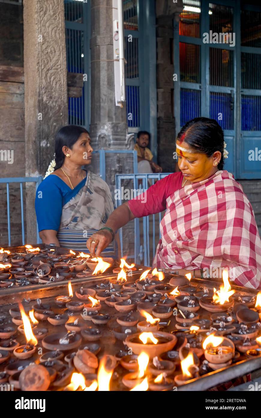 Lighting oil lamps in Kapaleeshwarar temple in Chennai, Tamil Nadu