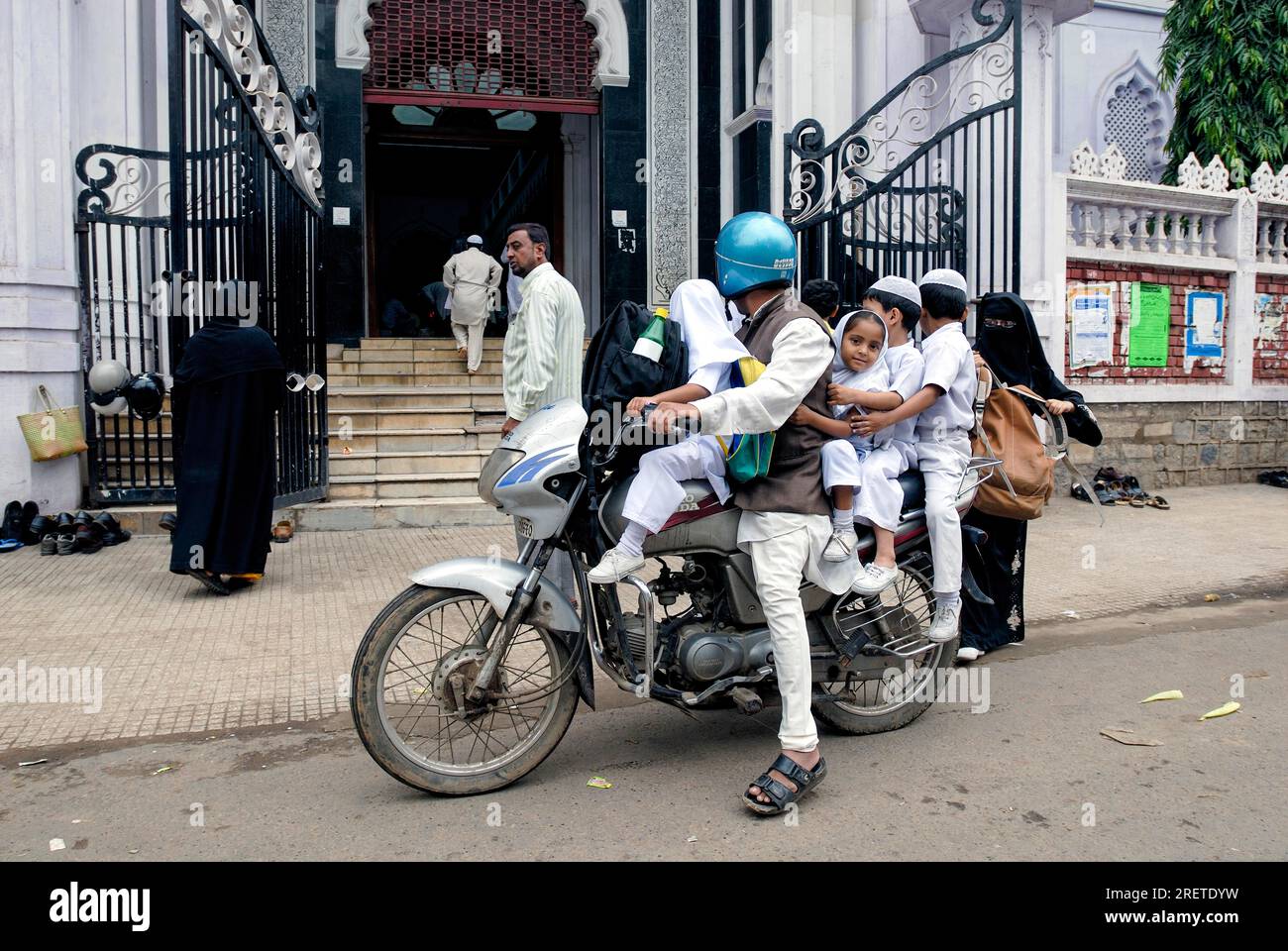 A family on a motorbike in front of Jamia Masjid in Bengaluru Bangalore, Karnataka, South India, India, Asia Stock Photo