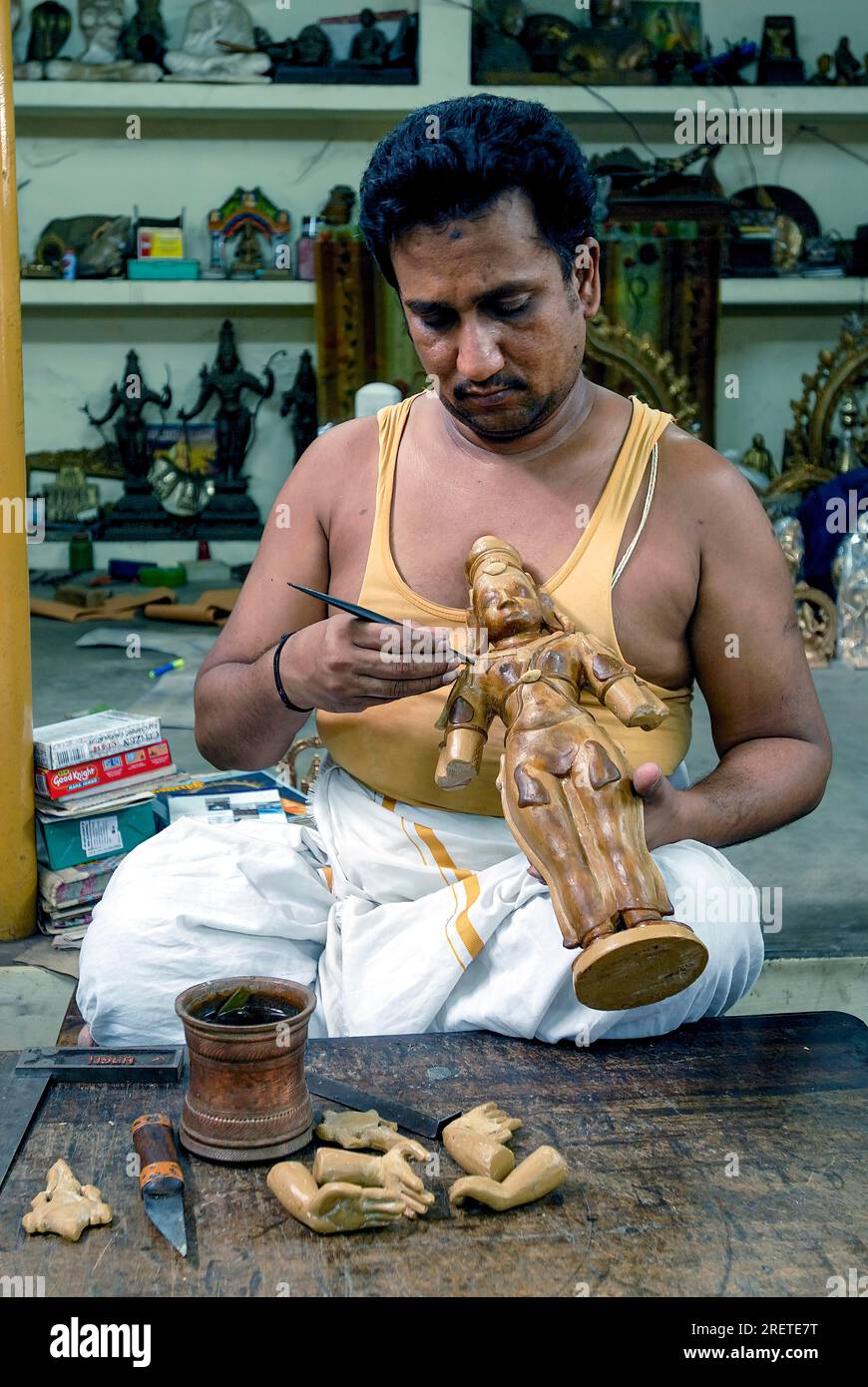 An artisan making wax mould for a bronze sculpture statue at Swamimalai