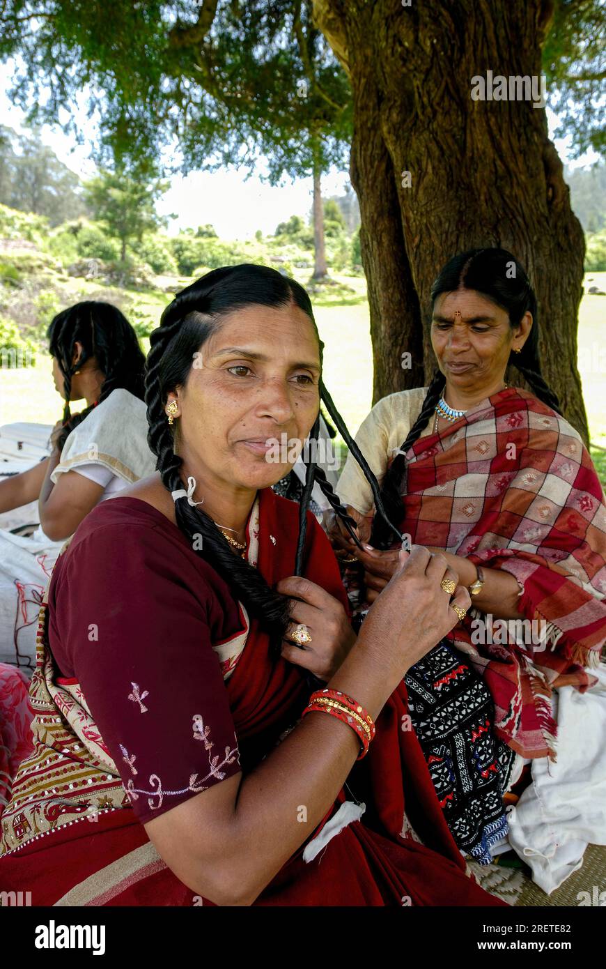 Toda woman plaiting her hair and making it curly with ghee, Nilgiris, Ooty Udhagamandalam, Tamil