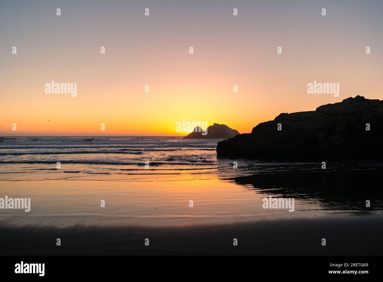Serene sunset reflections on the San Francisco shore. Stock Photo