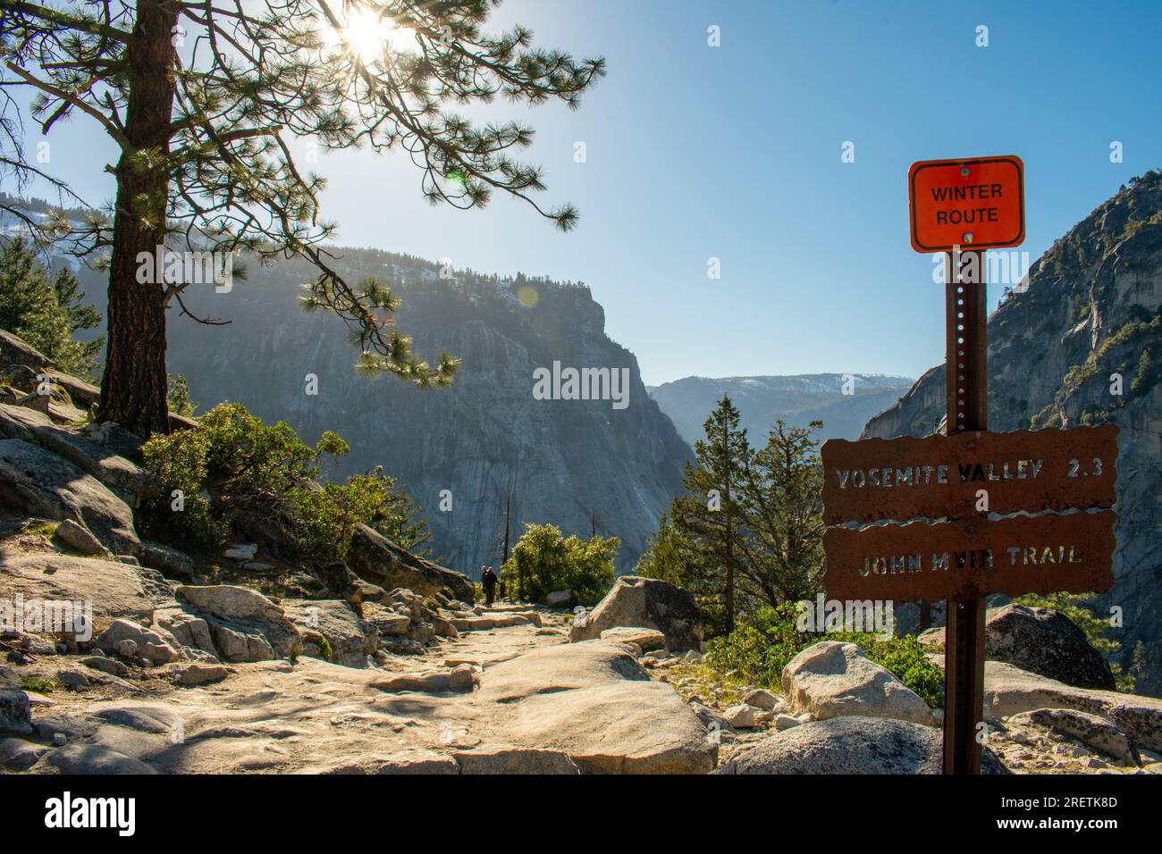 Morning sun bathes the John Muir Trail, leading adventurers towards Yosemite Valley. Stock Photo