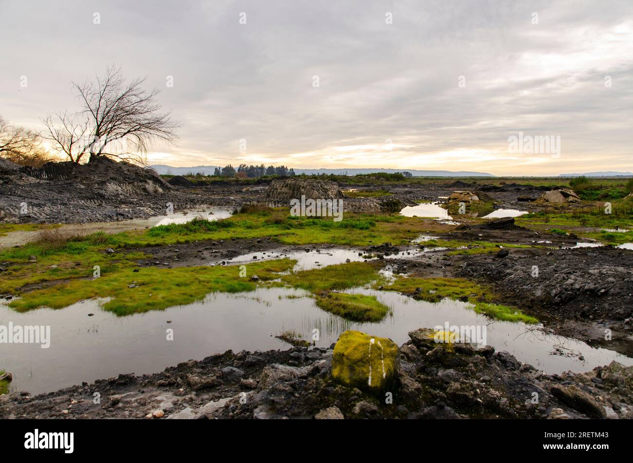 Industrial waste (scoria) from the Huachipato iron industry deposited in the Rocuant wetland in Talcahuano Stock Photo