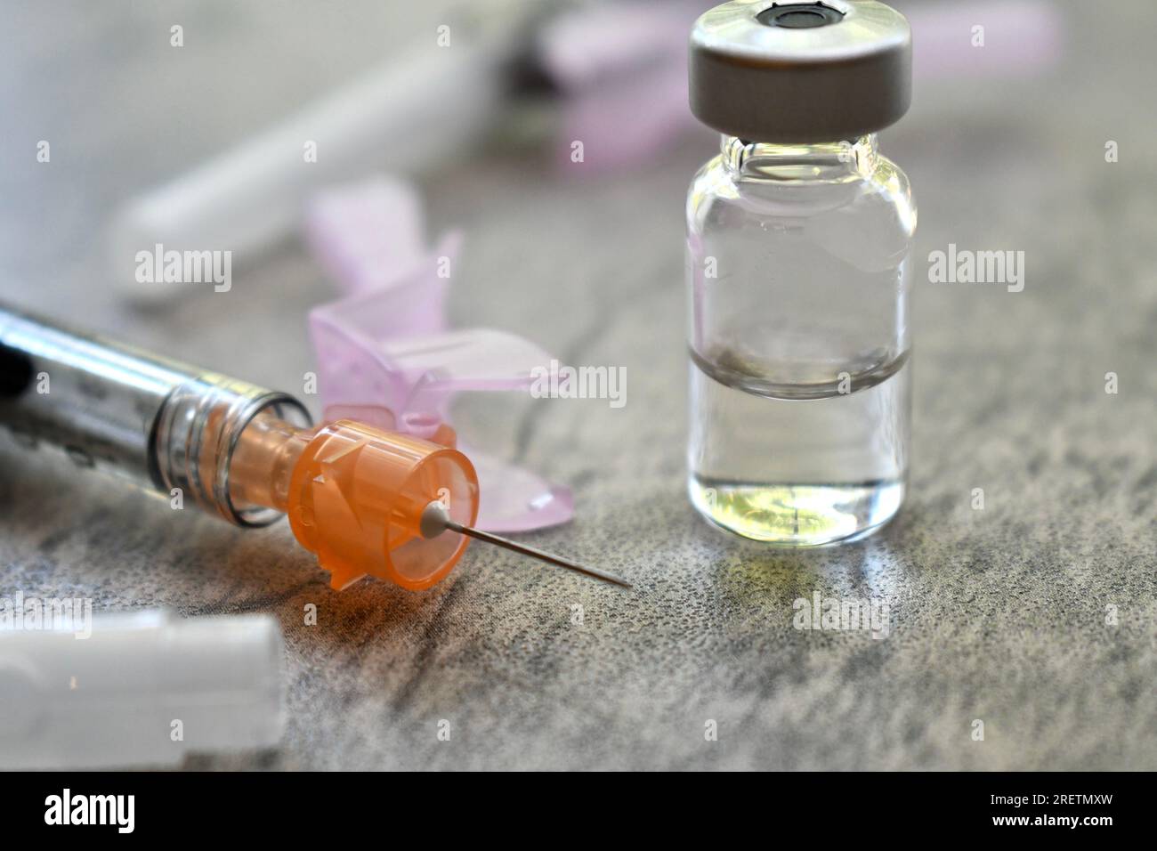 Vial of medicine with syringe on a grey surface Stock Photo