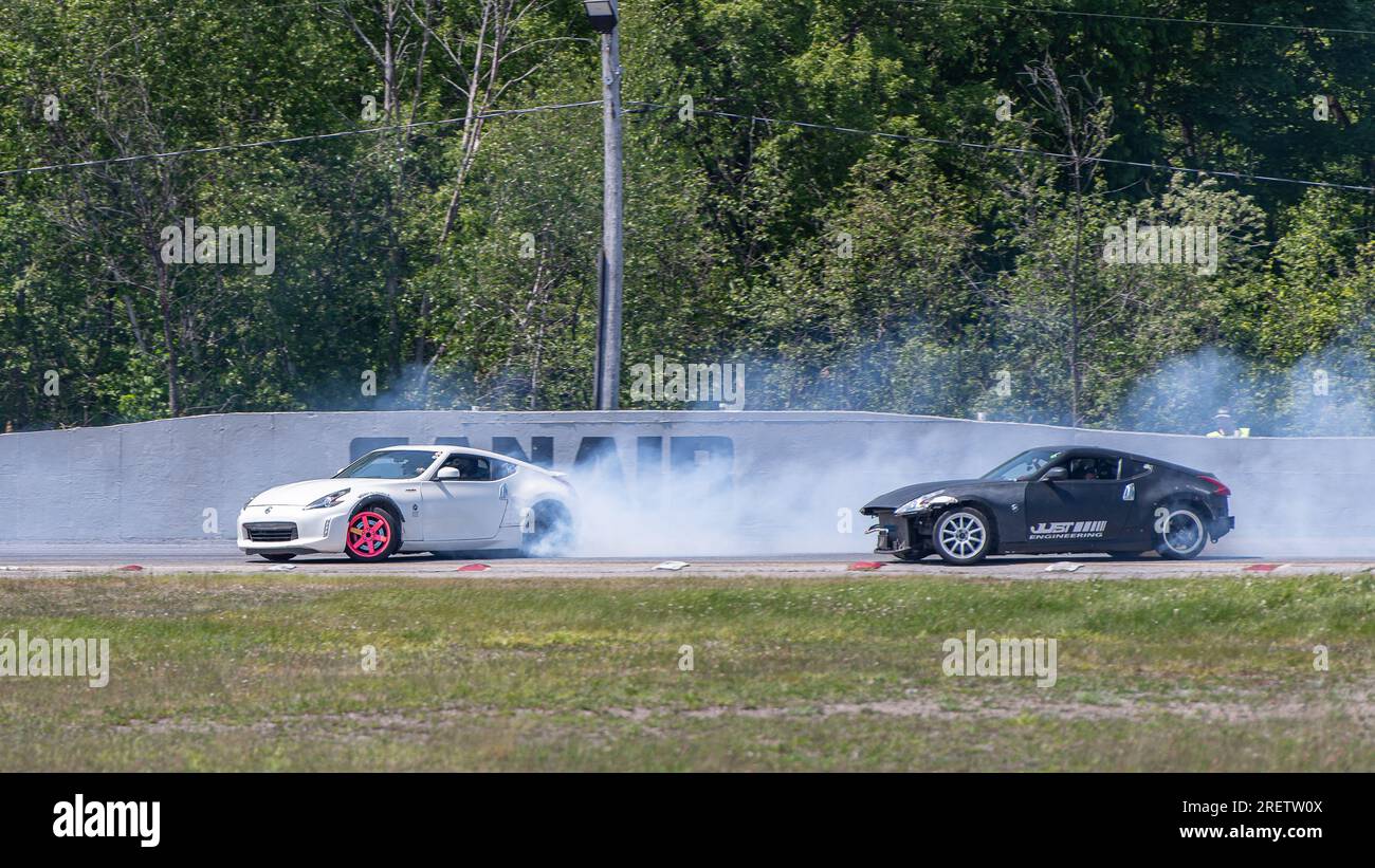 Car drifting auto racing event action with smoking tires - burning ...