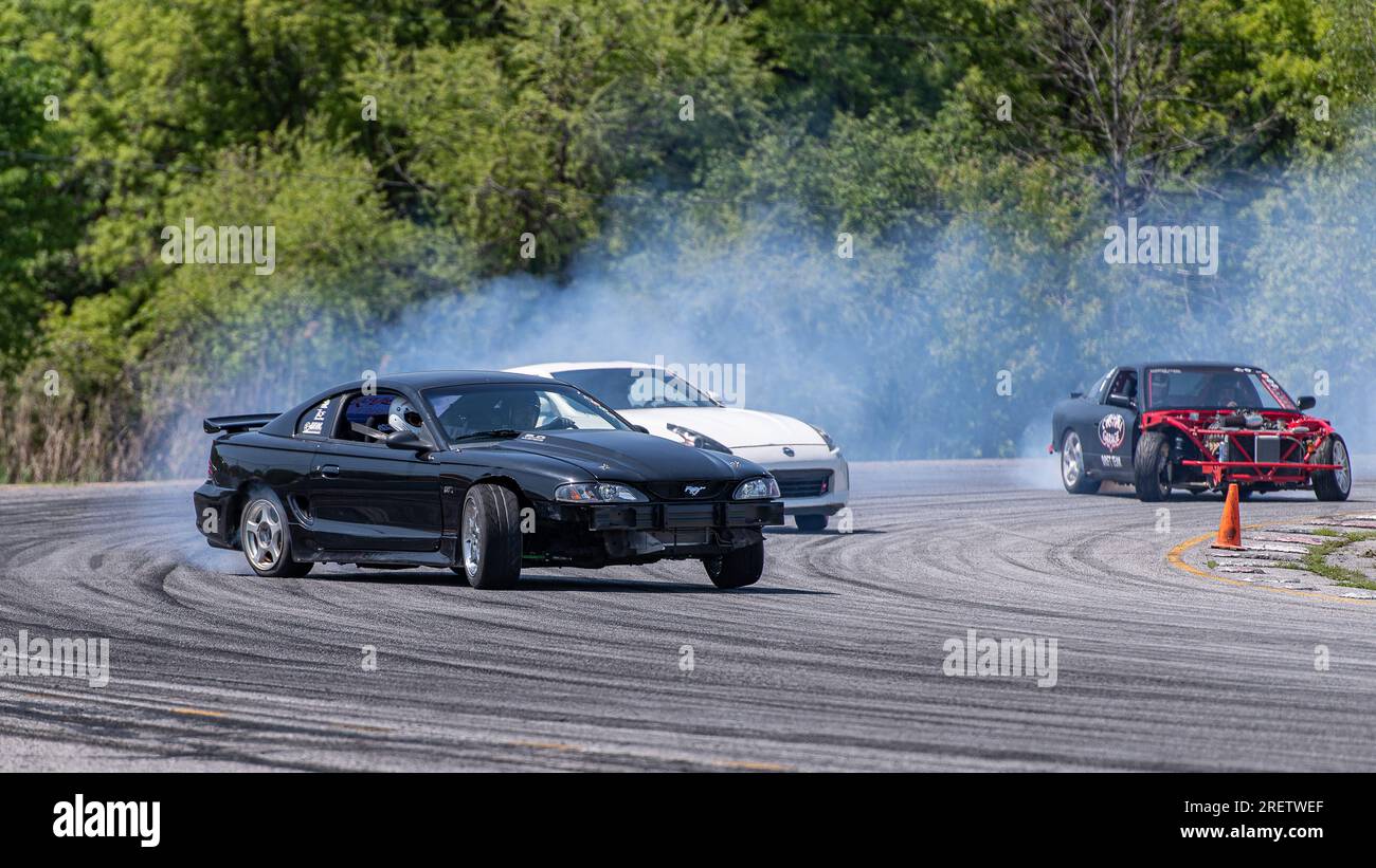 Car drifting auto racing event action with smoking tires - burning ...