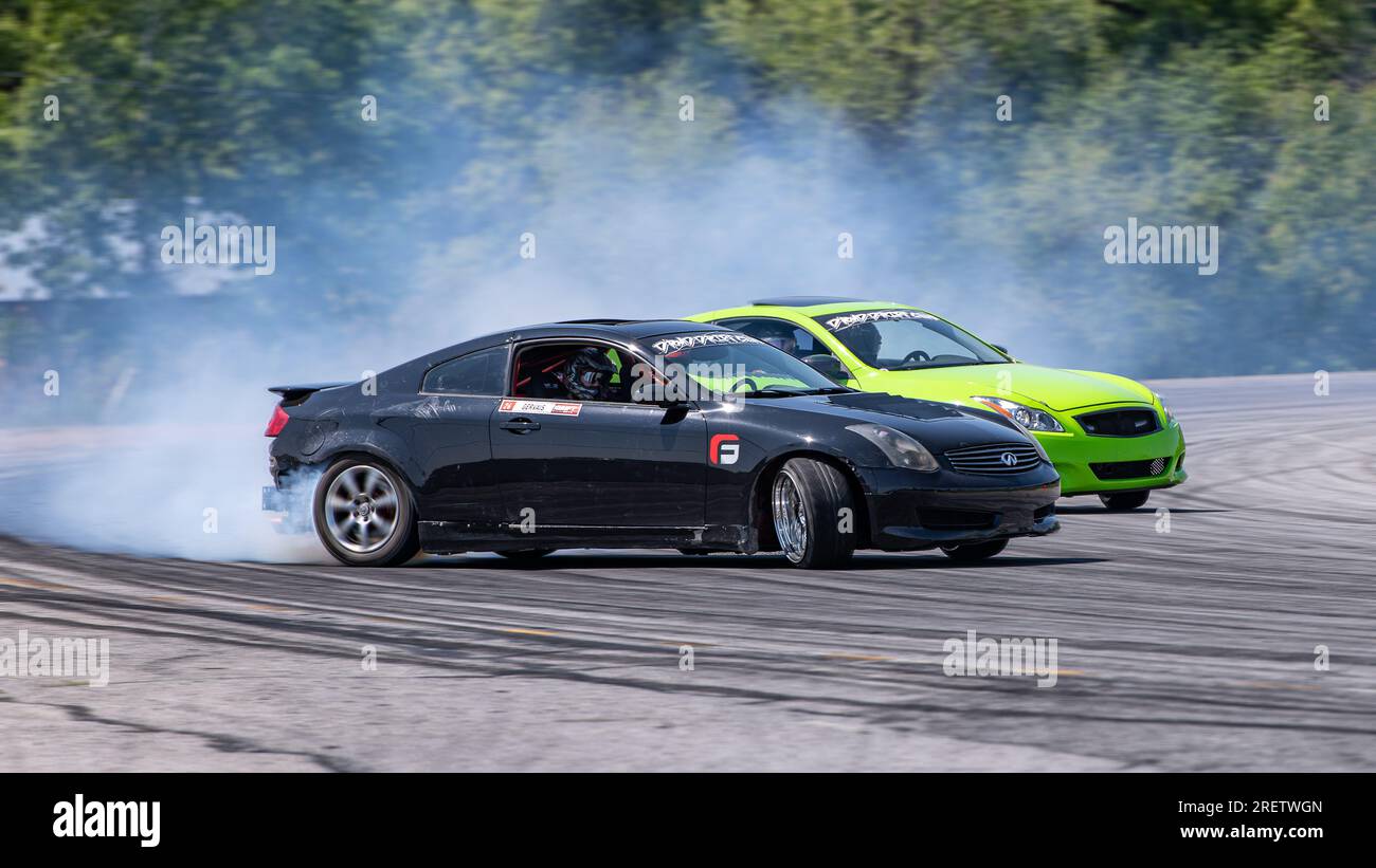 Car drifting auto racing event action with smoking tires - burning ...