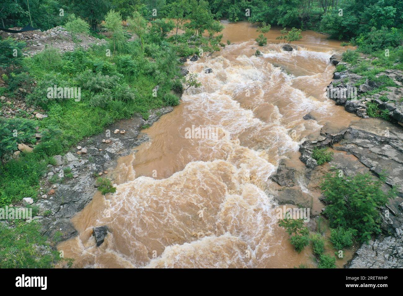 A flash flood caused by strong Typhoon 'Super Typhoon Doksuri' is seen in Zaozhuang city, Shandong province, China, July 30, 2023. Stock Photo